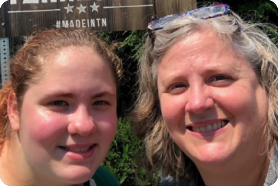 Ella and teacher smiling together